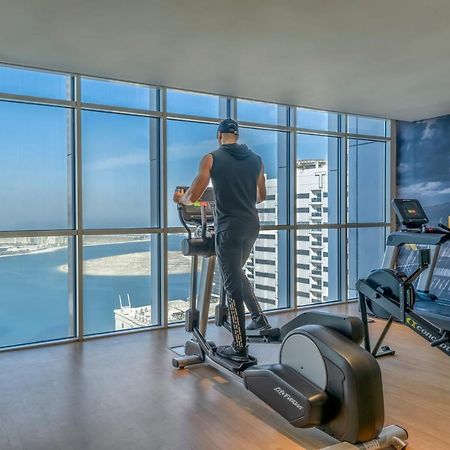 Pullman Sharjah Hotel Bagian luar foto A man using a cross trainer